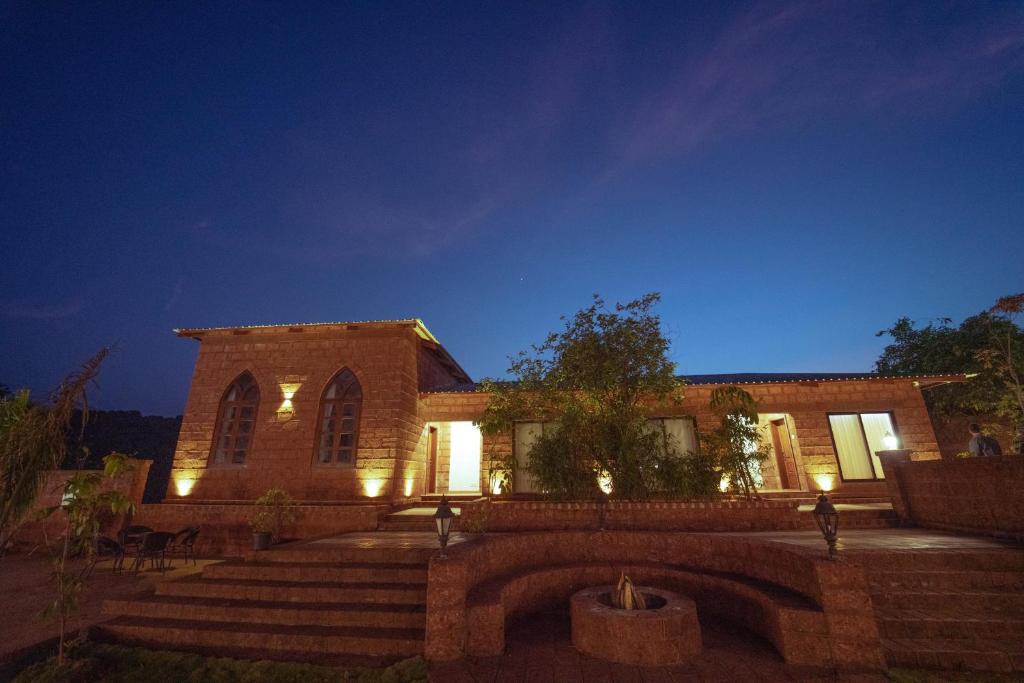 a building with stairs and lights in front of it at La Serene Resort and Spa in Mahabaleshwar