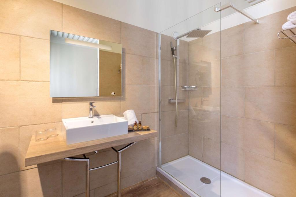 a bathroom with a sink and a shower at Best Western Marquis de la Baume in Nîmes