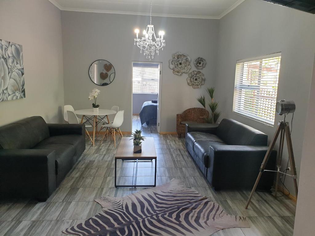 a living room with two couches and a zebra rug at ikibiki in Beaufort West
