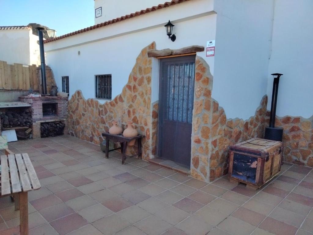 a courtyard of a house with a door and a stove at Casa Cueva Picoesquina in Guadix