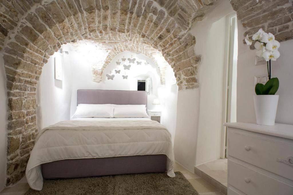 Ένα ή περισσότερα κρεβάτια σε δωμάτιο στο LE SUITES AL TORRIONE