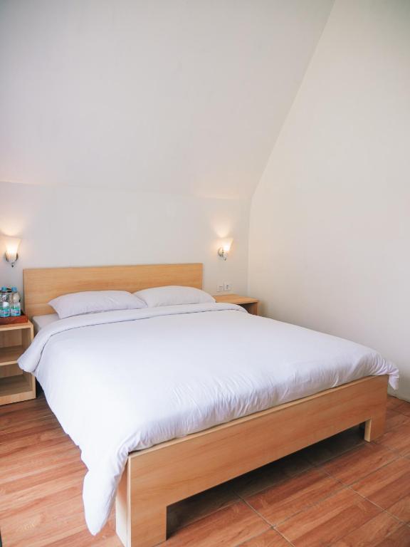 Postel nebo postele na pokoji v ubytování Tumpaksewu Homestay