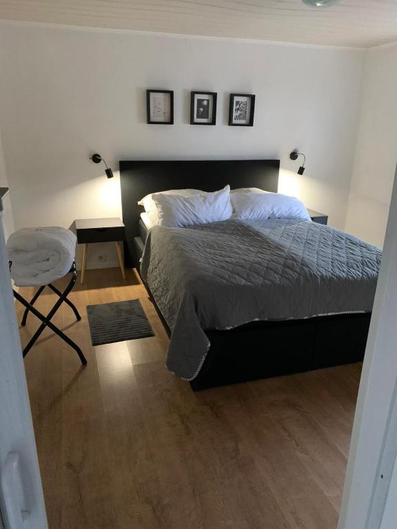 a bedroom with a bed and a table and a chair at Hexenhäuschen Wankendorf in Wankendorf