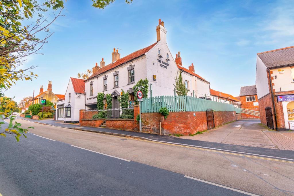 a street with a white building on the side of the road at The Forest Lodge in Edwinstowe