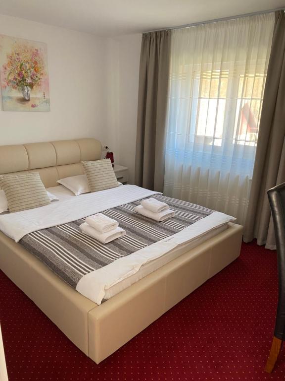 a bedroom with a large bed with towels on it at Guest House Piatra Craiului in Bran