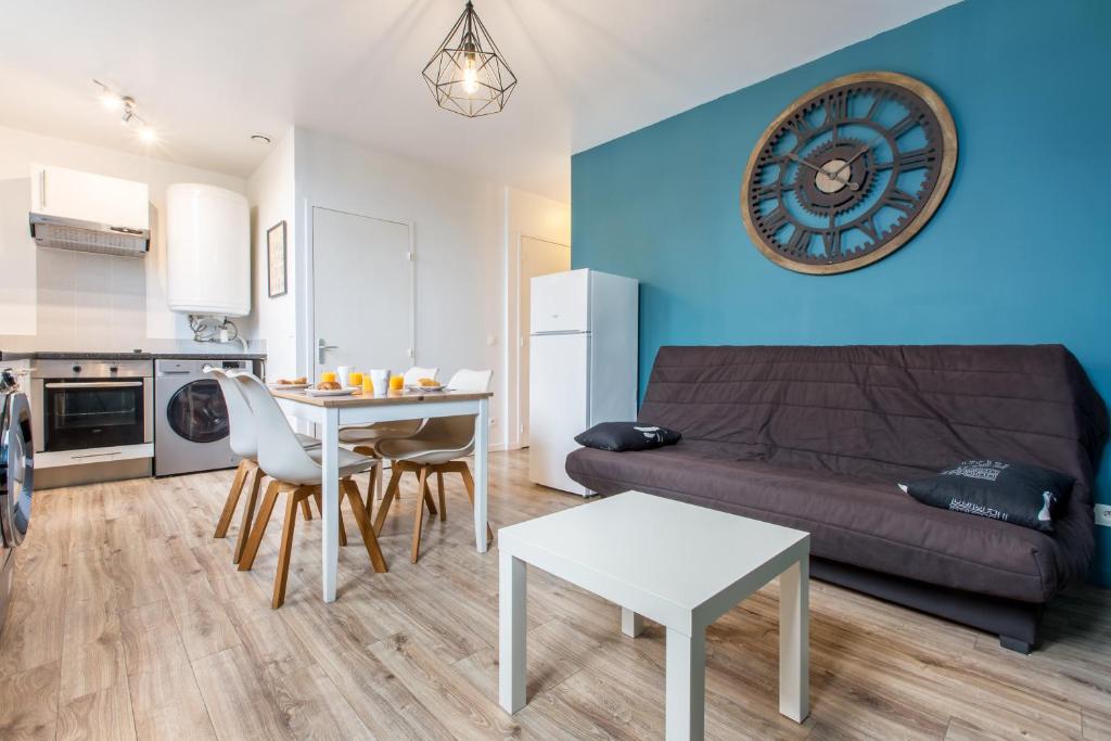 ein Wohnzimmer mit einem Sofa und einem Tisch in der Unterkunft Appartement style industriel, propre, WIFI Fibre in Roncq