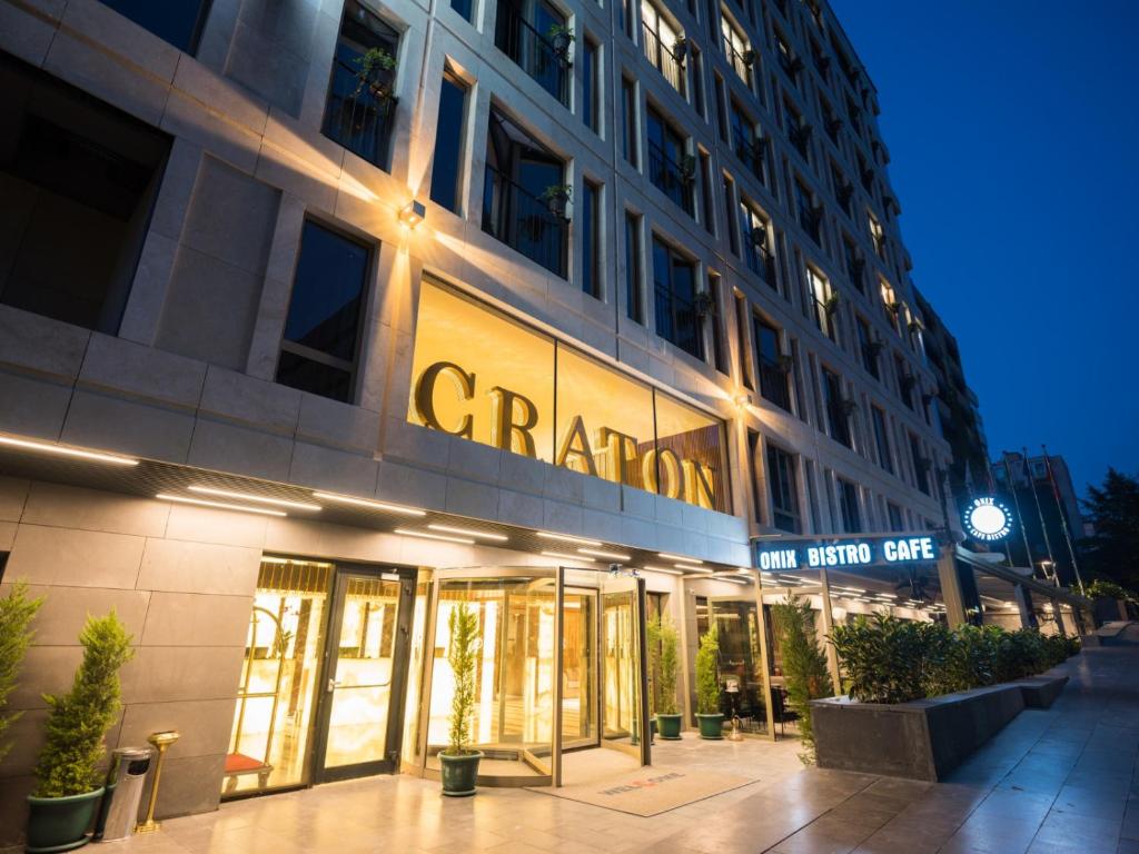 
a large building with a neon sign on the side of it at The Craton Hotel Sisli in Istanbul
