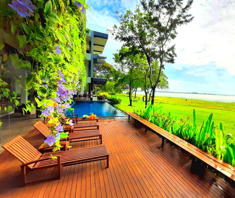 a row of benches sitting next to a building at The Lake Forest Hotel in Anuradhapura