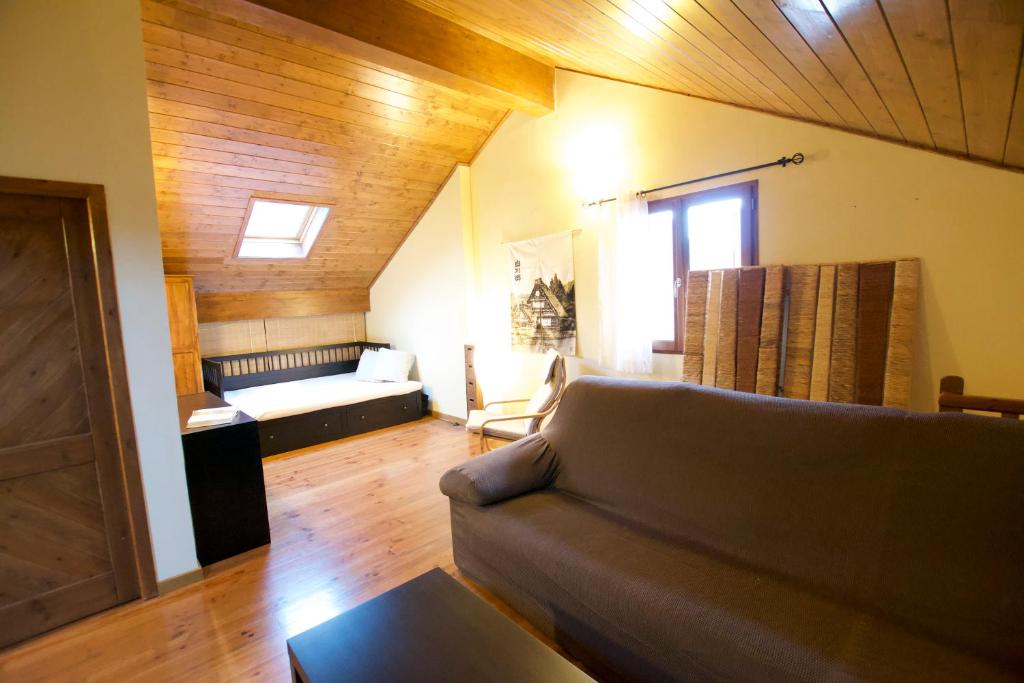 a living room with a couch and a table at Duplex el Pla de la Tour in Latour-de-Carol