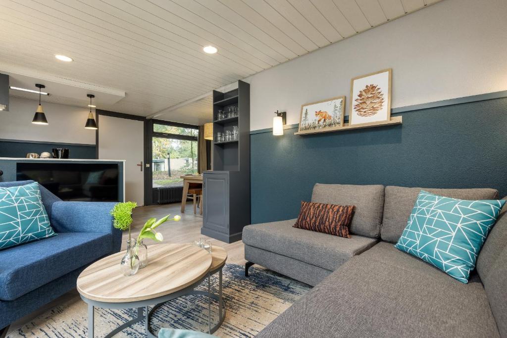 a living room with a couch and a table at Center Parcs Huttenheugte Drenthe-Overijssel in Dalen