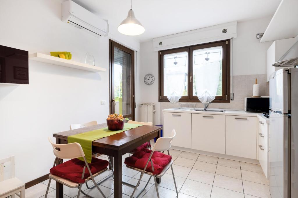 a kitchen with a table and chairs in a kitchen at Firenze Nova Comfortable Apartament with Terrace in Florence