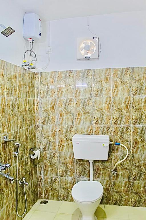 a bathroom with a toilet and a shower at Zcube Andaman in Port Blair