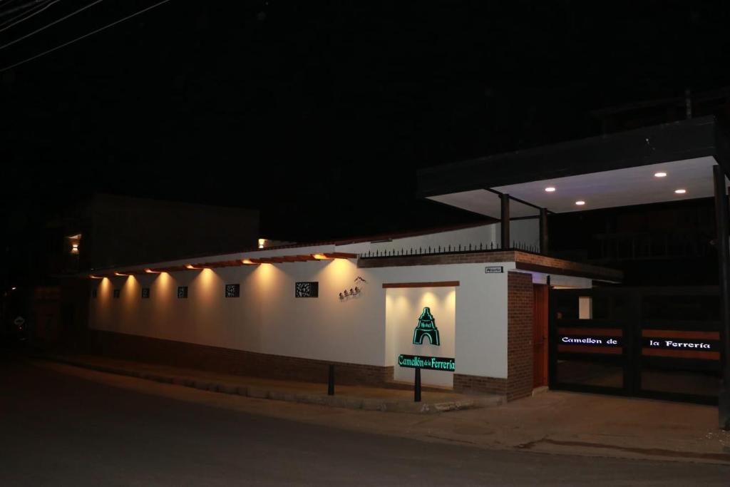 a building with lights on the side of it at night at Camellón de la Ferrería in Pacho