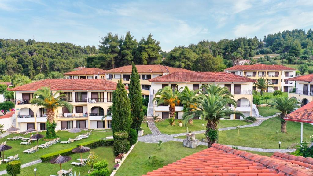an aerial view of a resort with palm trees at Chrousso Village in Paliouri