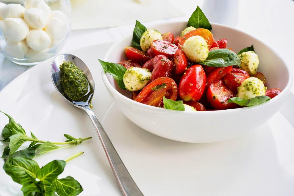 a bowl of salad with tomatoes and other vegetables at Chrousso Village in Paliouri