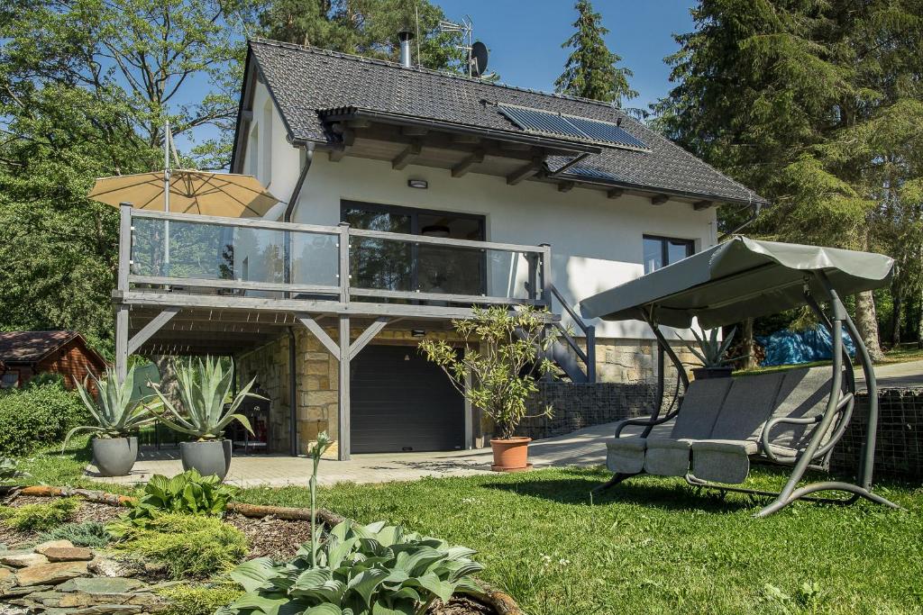 a house with a balcony and a patio at Chata Prachov**** in Jičín