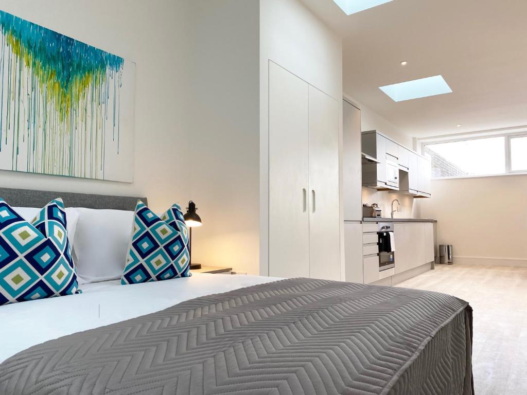 a bedroom with a large bed and a kitchen at Fleet Heights Apartment Eight in Fleet