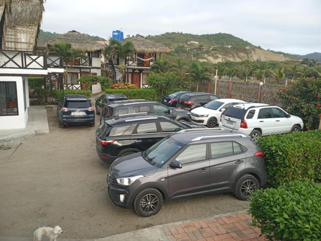 a group of cars parked in a parking lot at Cabañas El Manglar in Las Tunas