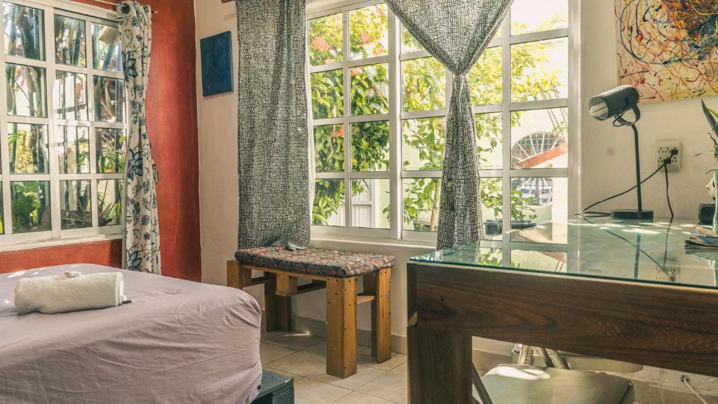 Postel nebo postele na pokoji v ubytování Casa del Pintor Chetumal