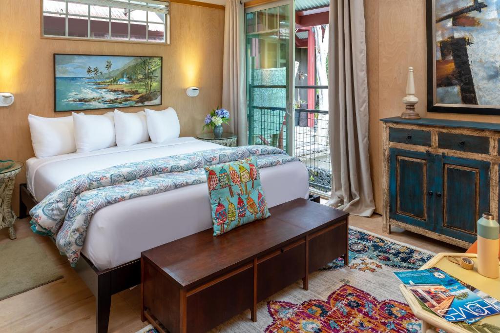 a bedroom with a large bed and a table at Volcano Village Estates in Volcano