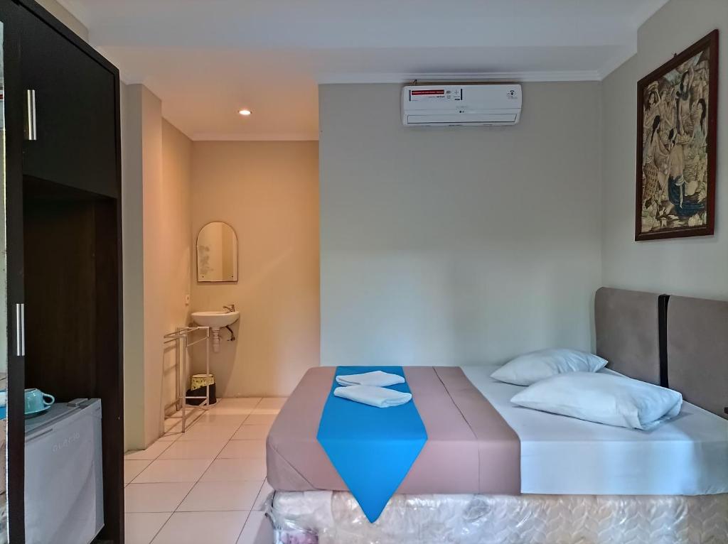 Postel nebo postele na pokoji v ubytování Sapta Petala Hotel