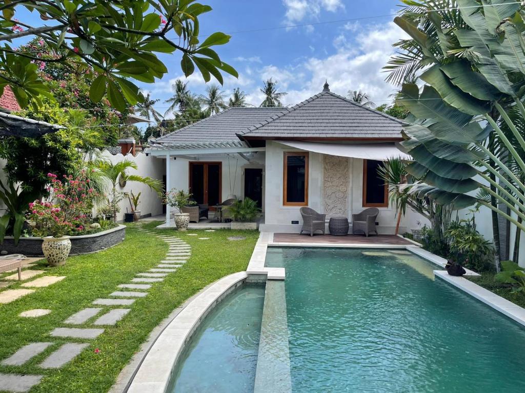 uma villa com piscina em frente a uma casa em Villa casa shanti deluxe em Lovina