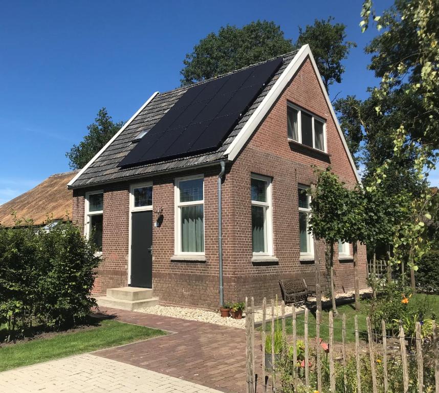 a house with solar panels on the roof at Guesthouse de Bovenboer in Nijeveen