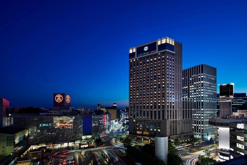 a tall building in a city at night at Yokohama Bay Sheraton Hotel and Towers in Yokohama