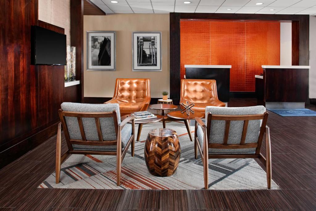 a waiting room with chairs and a table and a table at Four Points by Sheraton Memphis East in Memphis