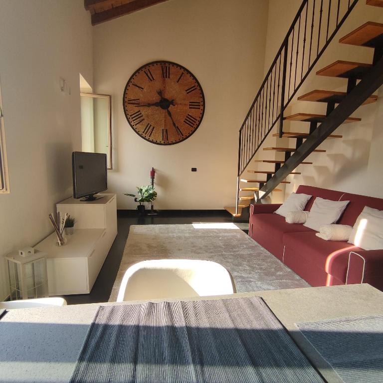 a living room with a large clock on the wall at La corte dell'orologio in Endine Gaiano