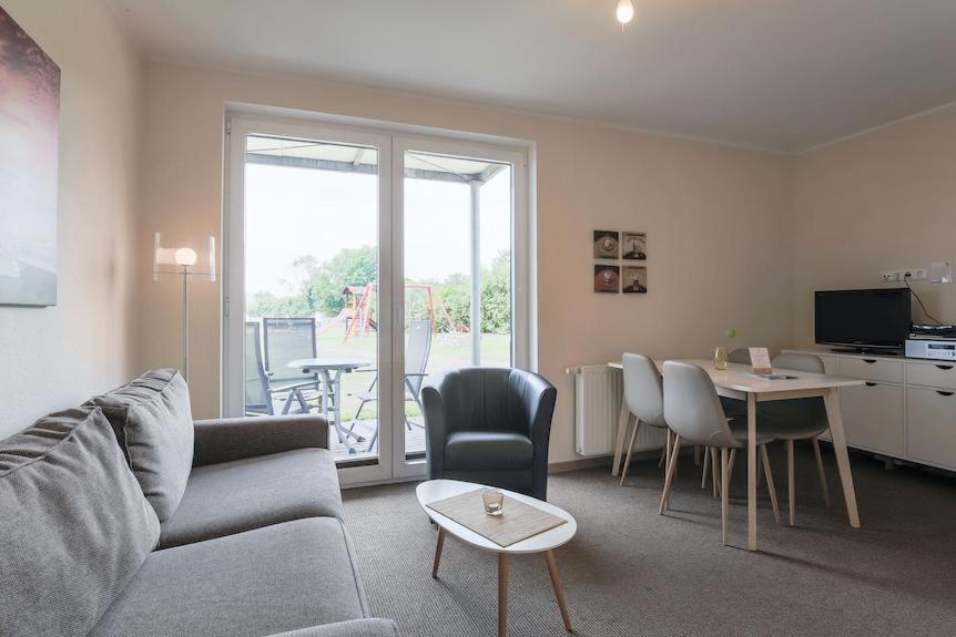 a living room with a couch and a table with chairs at Buedlfarm-An-Kueche in Sahrensdorf