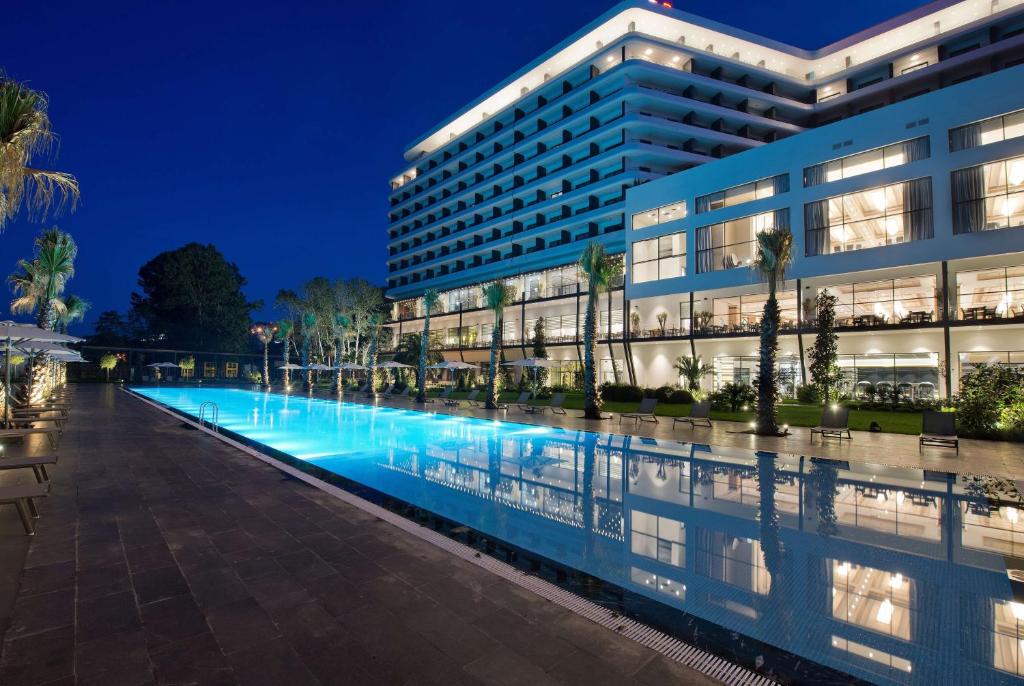 a building with a swimming pool at night at Ramada Plaza Hotel & Spa Trabzon in Trabzon