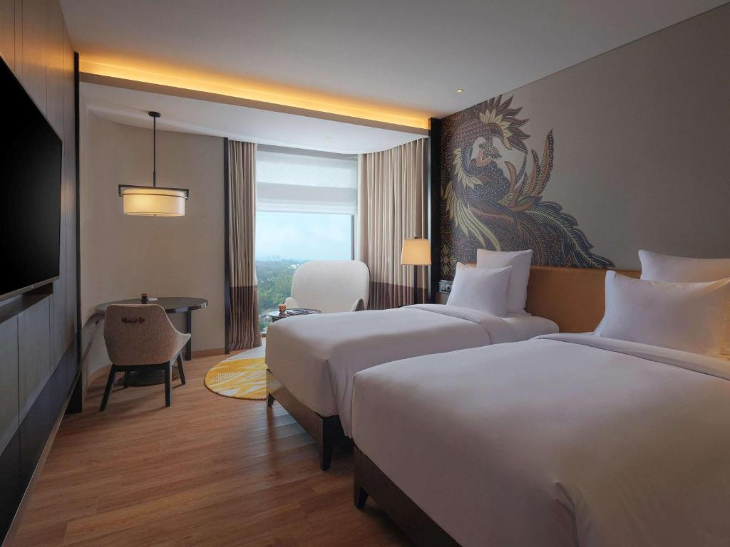 Rúm í herbergi á Pullman Bandung Grand Central