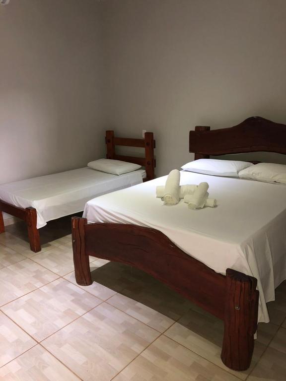 Uma cama ou camas num quarto em Pousada Encanto dos Anjos