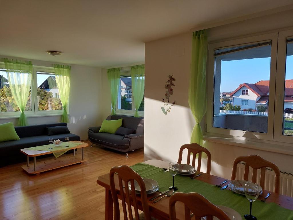 a living room with a table and a couch at Apartma TiJa in Moravske Toplice