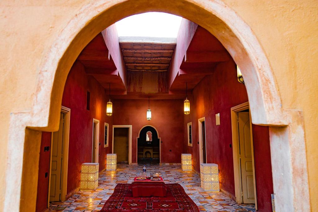 an empty hallway with an archway in a building at Dar Oussidi in Merzouga