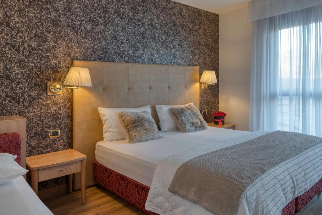 Postel nebo postele na pokoji v ubytování Hotel Sporting Trento
