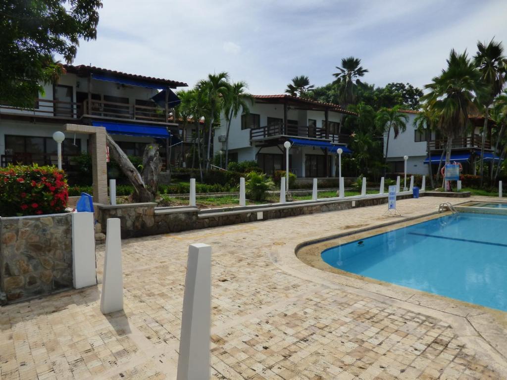 a resort swimming pool in front of some buildings at Puesta del sol in Santa Marta