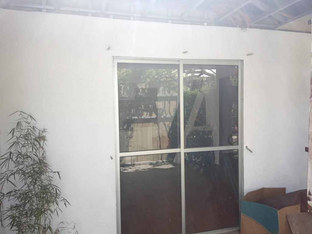a sliding glass door in a room with a plant at alquiler apto. para Brasileros cerca del estadio Centenario, para Conmebol in Montevideo