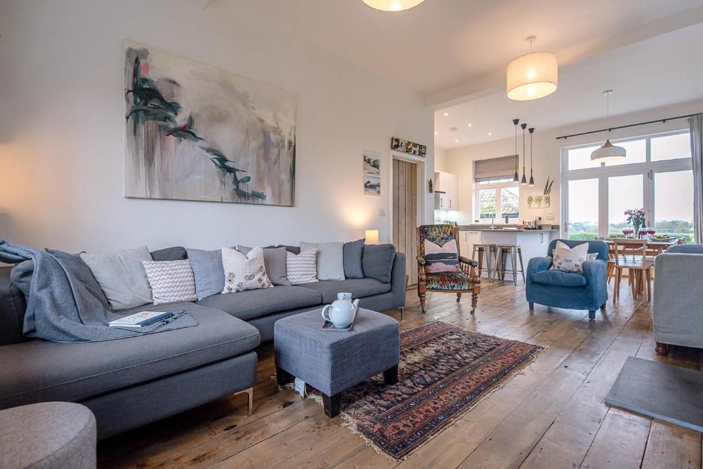 a living room with a couch and a table at The Artist's House in Orford