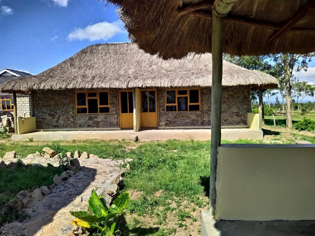 a small building with a straw roof at Le Tai Village Resort near Solio Game Reserve in Mweiga