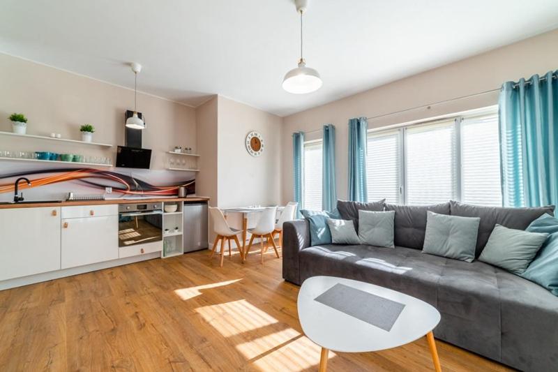 a living room with a couch and a table at Komfortowy Apartament w Karpaczu do 5 os. in Karpacz
