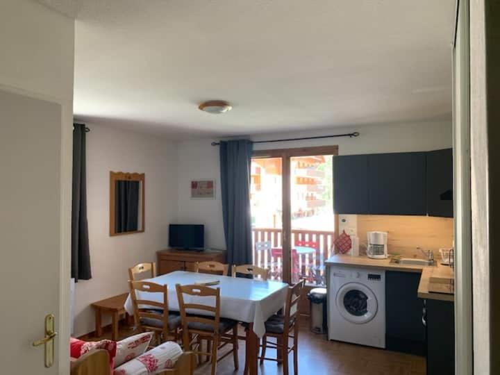 a kitchen and dining room with a table and chairs at le pied des pistes in Puy-Saint-Vincent