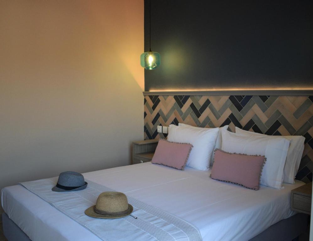 a bedroom with a bed with two hats on it at Villa Paxos in Gaios