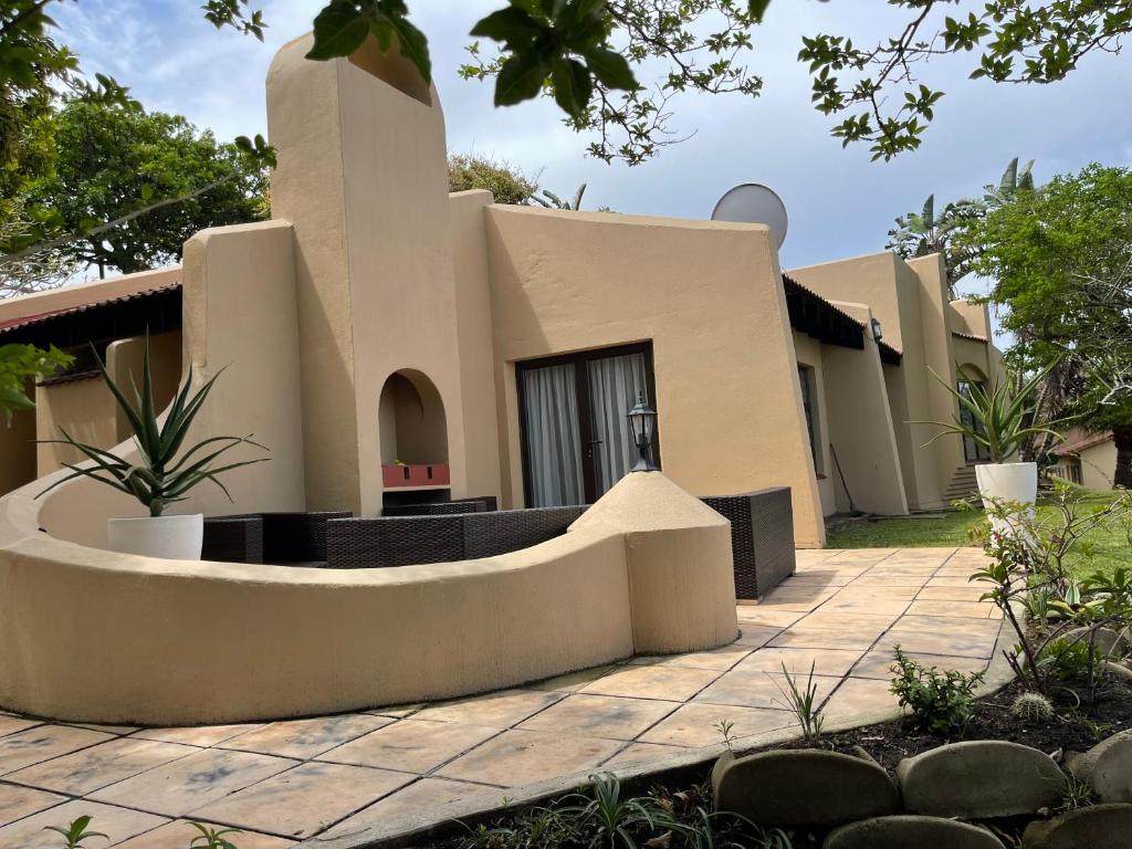 a home in the desert with a building at 63 Cest Si Bon - Shelly Beach in Shelly Beach