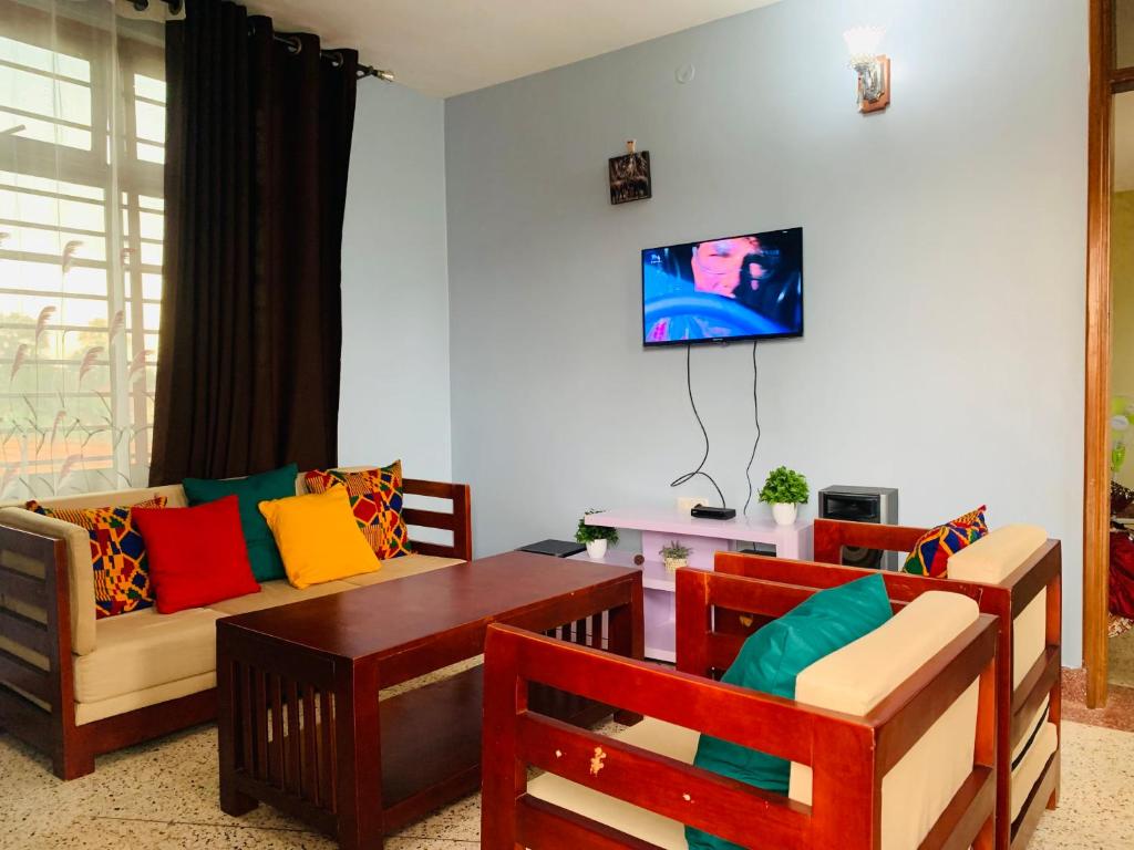 a living room with a couch and a table at Yonny’s Citadel in Jinja