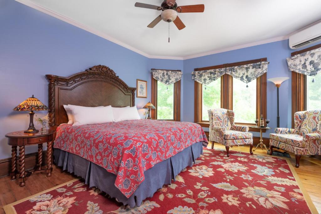 
a bedroom with a large bed and a large window at Sinclair Inn Bed & Breakfast in Jericho
