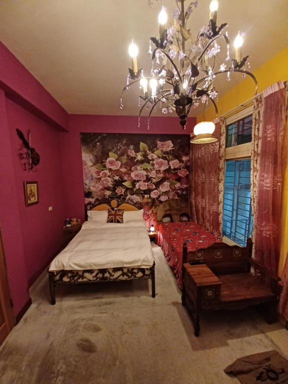 a bedroom with a bed and a chandelier at Hualien Seaside B&amp;B in Hualien City