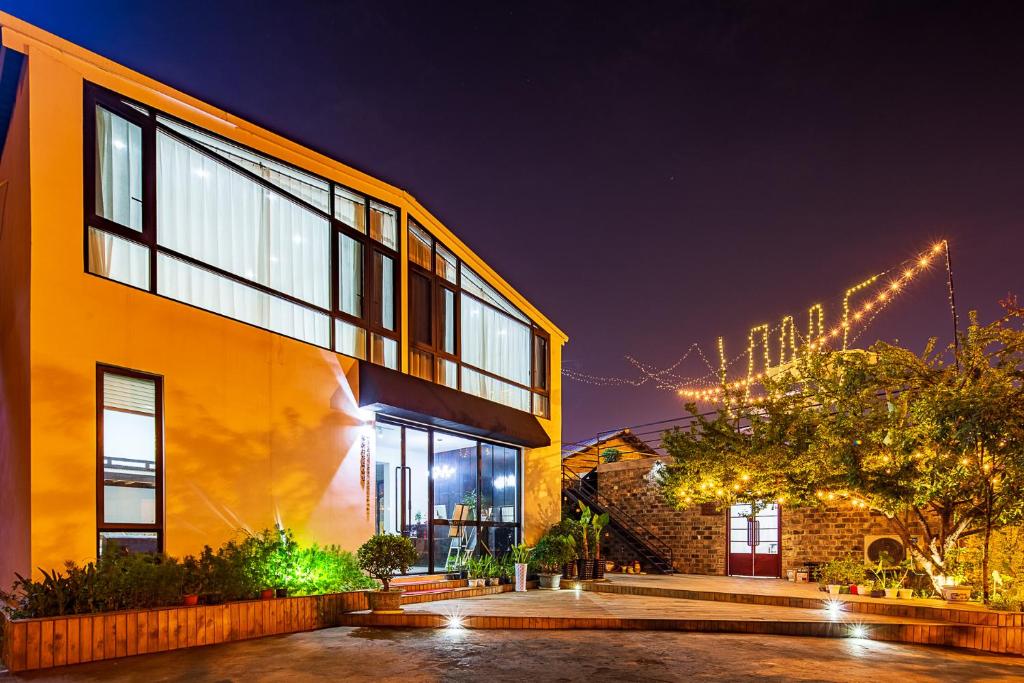 a large yellow building with christmas lights at Thirty One in Zhangjiajie