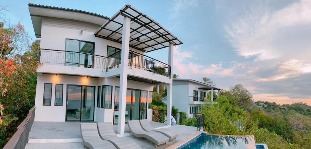 a white house with a pool in front of it at High Life Villas in Salad Beach